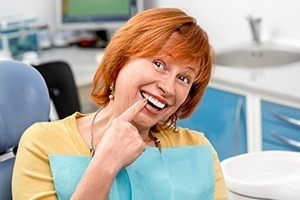 Senior woman pointing to smile