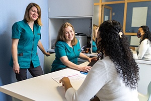 Dental receptionists helping a patient